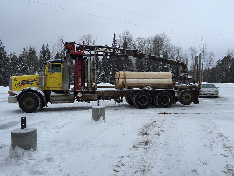 Truck delivering logs